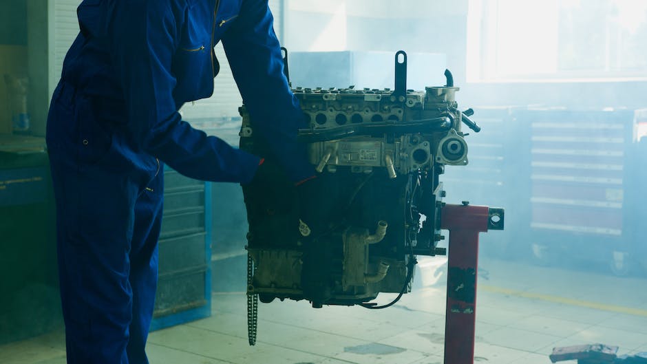 Photograph of a person inspecting a used car.