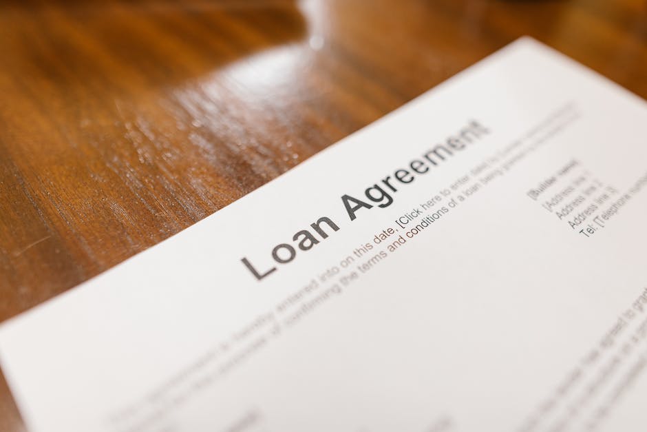 Image of a person signing a car loan agreement